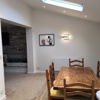 White dining room with skylight