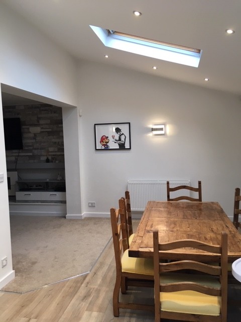 White dining room with skylight